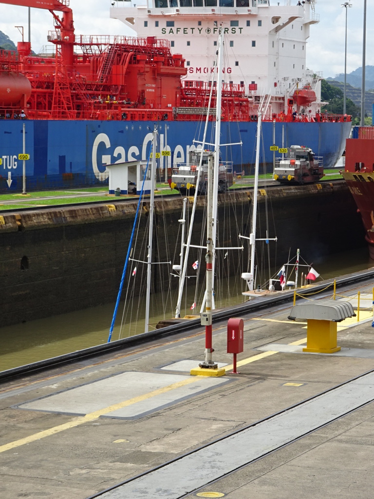 The lock closest in the picture has drained out its water and all you can see is the top of the little sail boats. A big ship has rolled into the lock just beyond it.