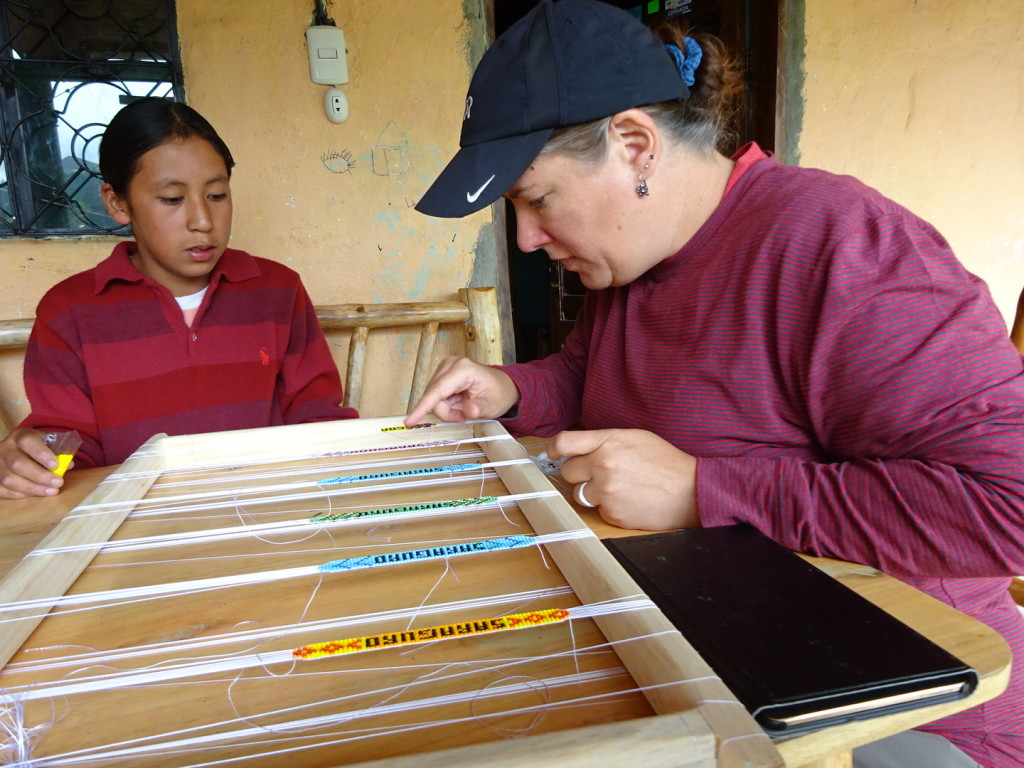 Samual teaching me how to do beeding. Yet another thing that is harder than it looks.  You can see our tablet is out...that is because we have a translation app on it and occassionally we would type a word in so we could continue with our lessons.