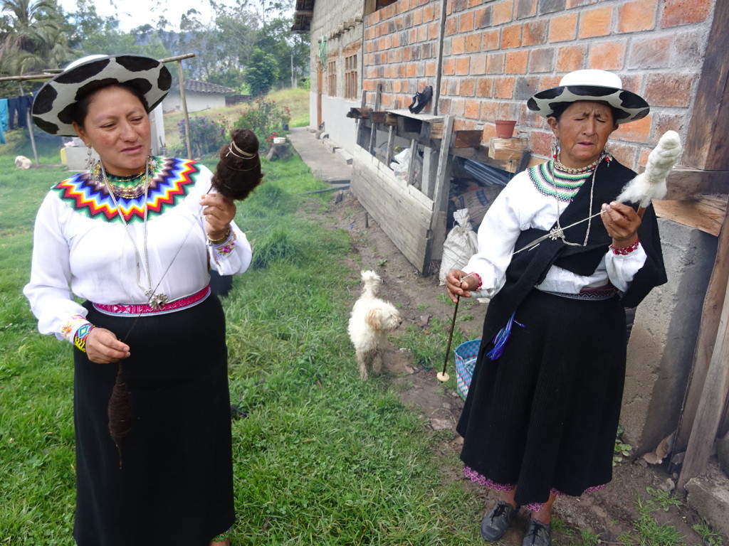 Luiza and Abellina pulling yarn from cleaned wool. The white and dark are both natural colors from different types of sheep.