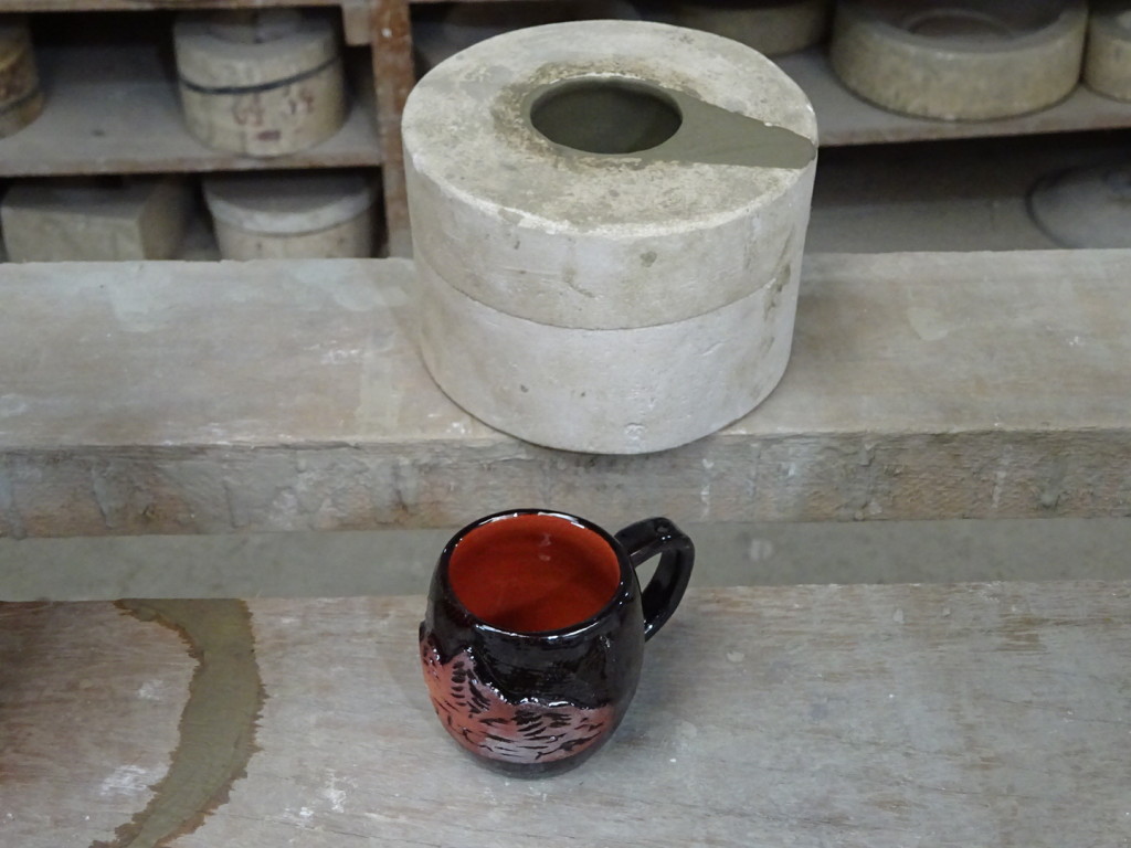 ...then he pours out the slip so that he has a hollow mug form inside the mold!