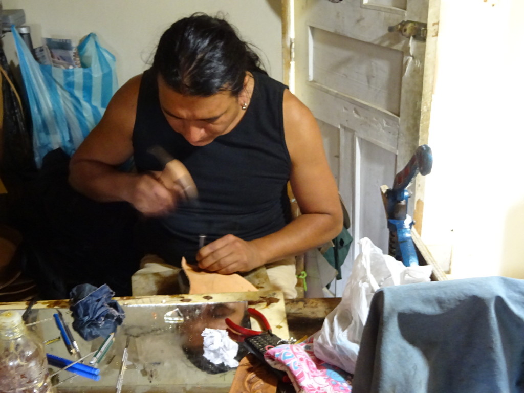 Hand-tooling his leather...