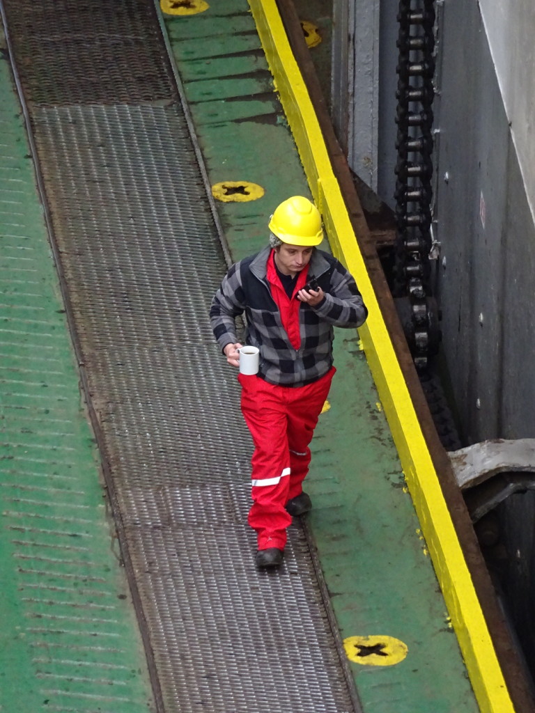 Worker helping load the vessel...and as any good Seattleite can tell you... you need a cuppa coffee to do a job right.