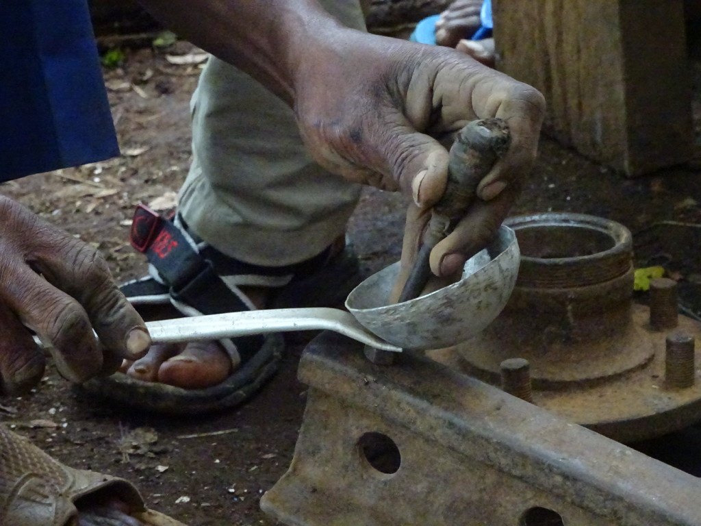 Riveting my ladle together. Underneath is simple nut which gives the space for the rivet to be hammered on.