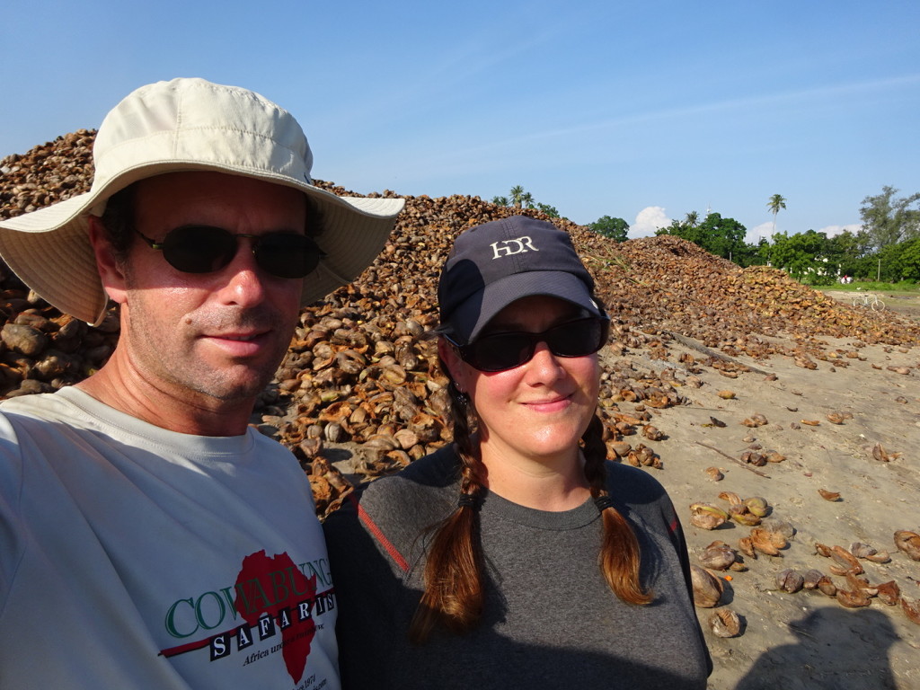 This is kind of sad and that's why the smiles are fake. That is a mountain of coconut shells. They are farmed across the river and brought over. They are shelled and sold. The shells that remain are bagged up and sold for cooking fires at home. It's totally depressing seeing people toiling overing this unending pile, just trying to eek out a living.