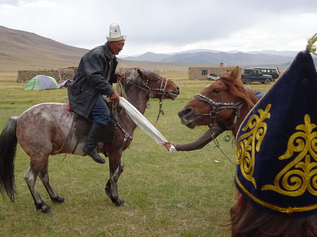 Yes, that's Mauitkhan and Erlan playing tug-o-war. On horseback. It was like a dance, they were so good! Circling each other and spinning the sack they used for tugging, it went on for at least 5 minutes. All our jaws dropped as these badasses just kept going and going!