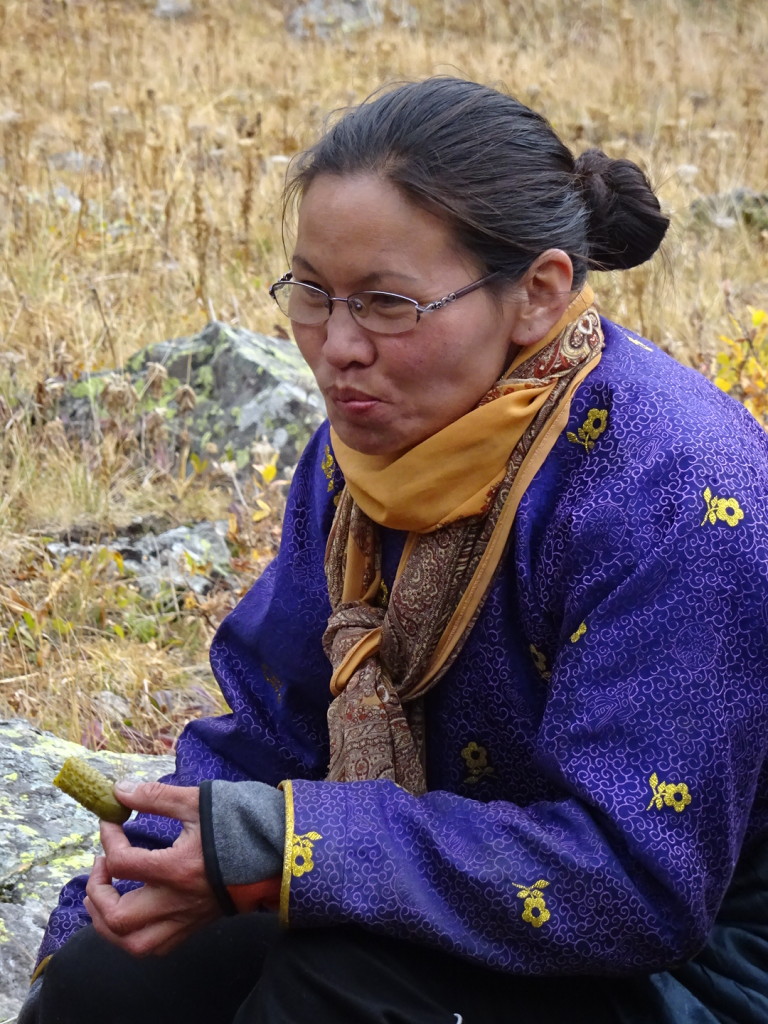 Saraa, our cook, snacking on everybody's favorite lunch pickles before leading Trusty down the Pass of Death.