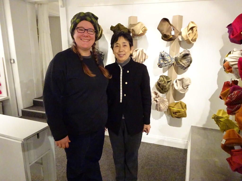 Anner and ___ in front of a bunch of hats.