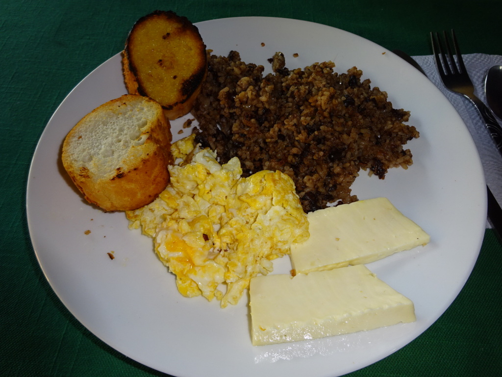 This is a typical Costa Rican breakfast: rice & beans, scrambled eggs, toast, and cheese or meat - like chicken.