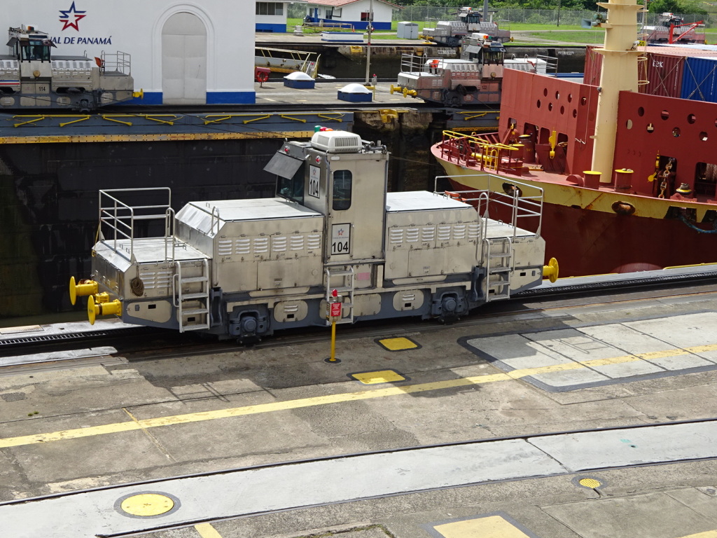 These modified train engines run on tracks next to the locks and help tow/brake the big ships. 