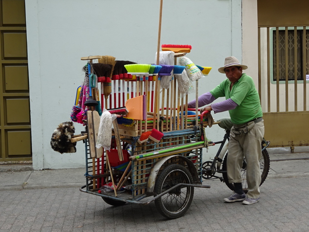 Selling brooms from a bicycle has got to be a hard way to make a living!