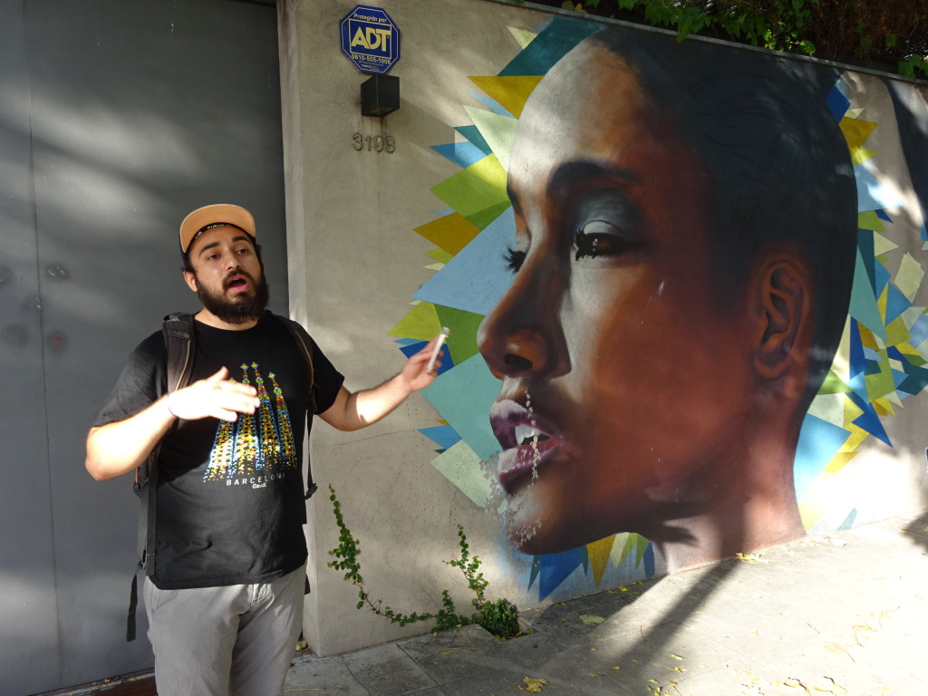 Ollie with a painting by Primos, a pair of cousins who paint mostly faces of black Argentinians for their beauty and as a statement on the slavery many were put under.