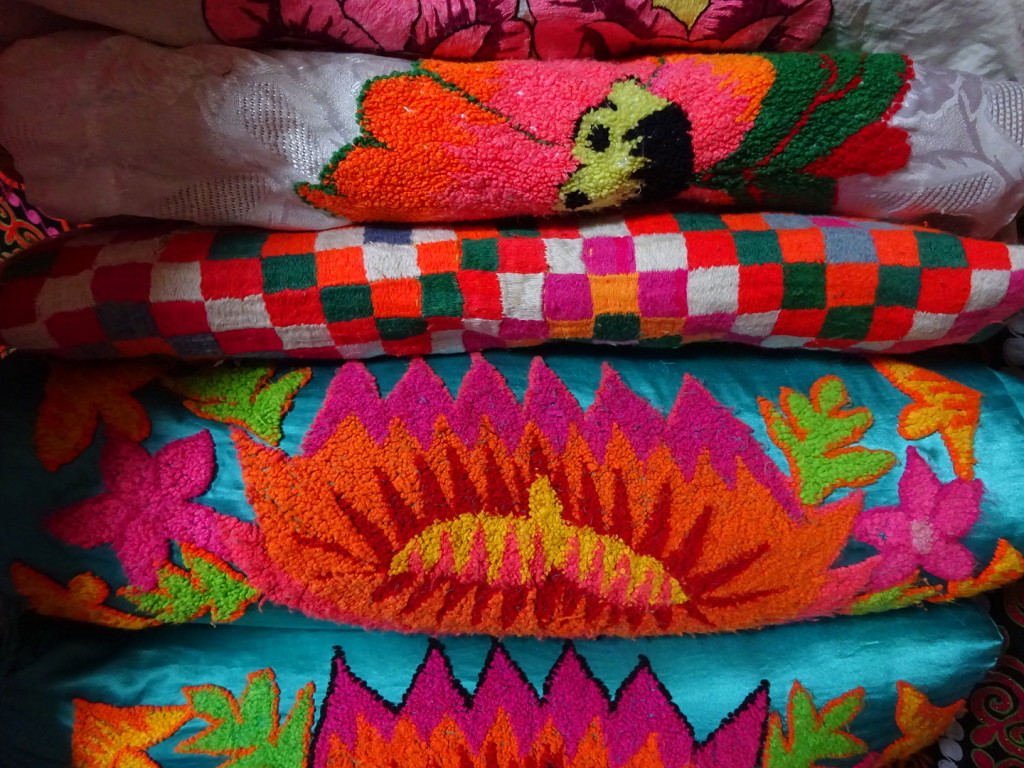 Absolutely love the colors inside the ger. A stack of pillows like this one means the family can take in many guests.